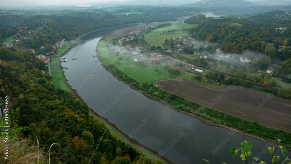 View from viewpoint of Bastei in Saxon Switzerland Germany to the town city and the river Elbe on a sunny day in autumn View from viewpoint of Bastei in Saxon Switzerland Germany to the town city and the river Elbe on a sunny day in autumn