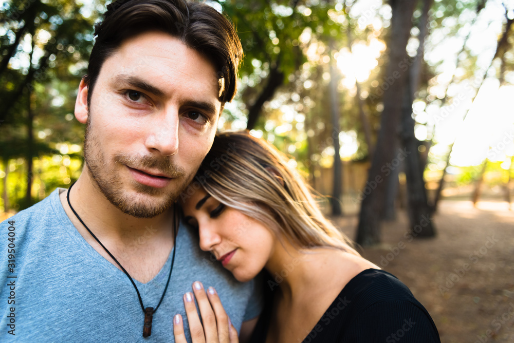 Woman leaning on her boyfriend's shoulder, while he looks at the camera. Woman leaning on her boyfriend's shoulder, while he looks at the camera.