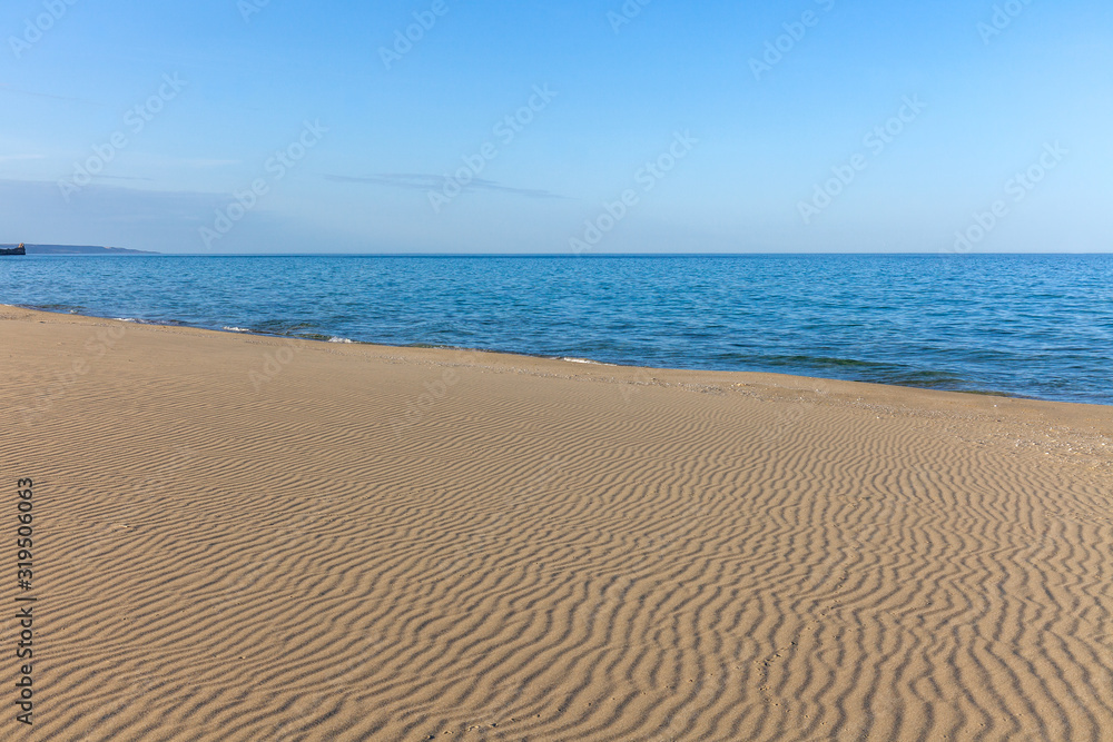 View of blue sea waves at sandy beach. Horizon line. Caspian Sea, sandstone coast. ustyurt. Selective focus, long shutter speed View of blue sea waves at sandy beach. Horizon line. Caspian Sea, sandstone coast. ustyurt. Selective focus, long shutter speed