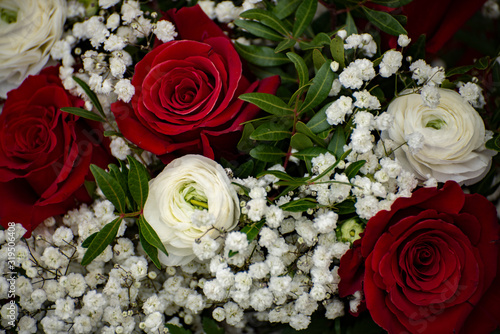 Bouquet of beautiful red and white roses with bridal flowers. Close up of bouquette for bride.