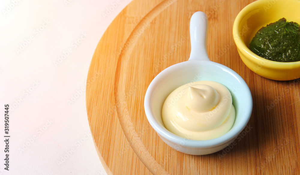delicious and hot sauce in a light blue and yellow bowl on a cutting board. tasty exotic cuisine and spicy spice concept delicious and hot sauce in a light blue and yellow bowl on a cutting board. tasty exotic cuisine and spicy spice concept