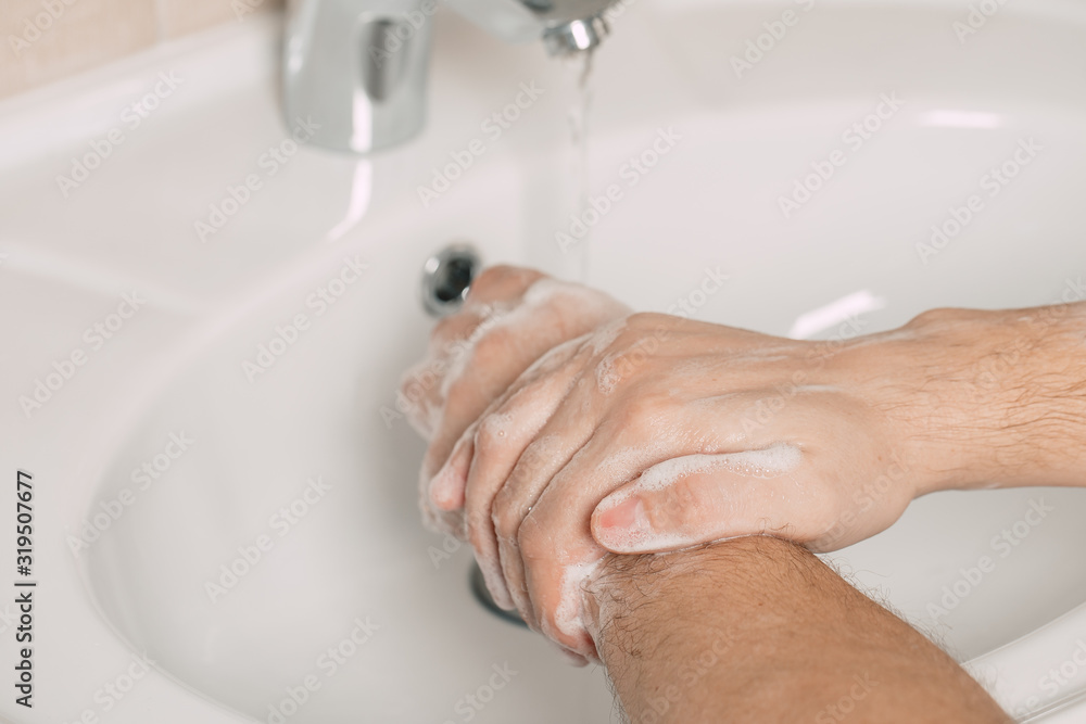 Washing hands under the water tap or faucet without soap. Hygiene concept detail. Beautiful hand and water stream in bathroom. Washing hands under the water tap or faucet without soap. Hygiene concept detail. Beautiful hand and water stream in bathroom.