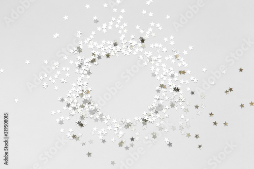 Silver confetti and stars and sparkles on a light background. Top view  flat lay. Copy text. holiday background. For Christmas  New Year  Valentine s Day
