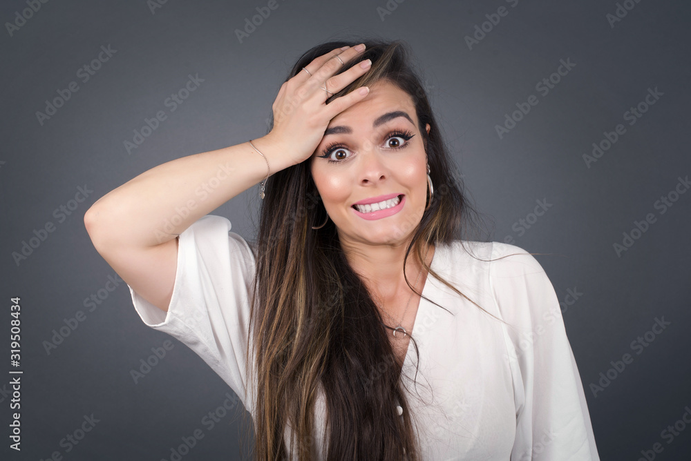 Oops, what did I do? Beautiful blonde woman holding hand on forehead with frightened and regret expression. Wearing casual clothes standing outdoors. Oops, what did I do? Beautiful blonde woman holding hand on forehead with frightened and regret expression. Wearing casual clothes standing outdoors.