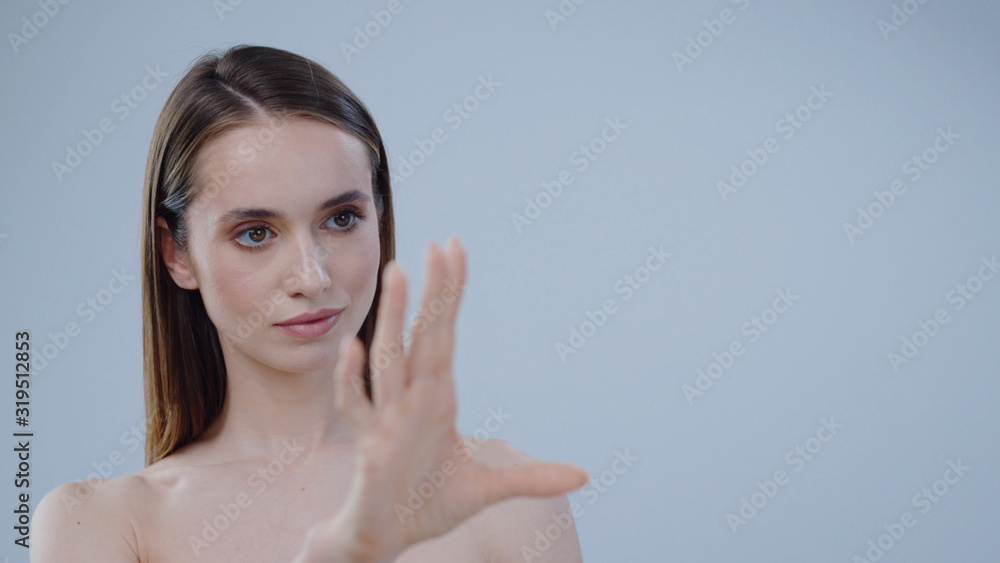 Serious young naked woman look touch switches hands around grey background care skincare female perfect studio adult attractive beautiful face girl makeup model cute pretty close up slow motion Serious young naked woman look touch switches hands around grey background care skincare female perfect studio adult attractive beautiful face girl makeup model cute pretty close up slow motion