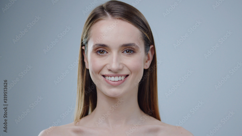 Charming face young naked woman look at camera smiling grey background care  skincare female perfect studio adult attractive girl makeup model cute  pretty close up portrait slow motion Stock Photo | Adobe