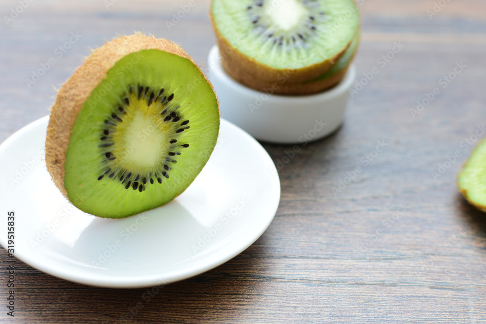 Fresh whole kiwi and half kiwi showing its texture Fresh whole kiwi and half kiwi showing its texture