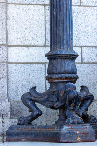 Wallpaper Mural An decorative, iron light post in front of a granite wall. Torontodigital.ca