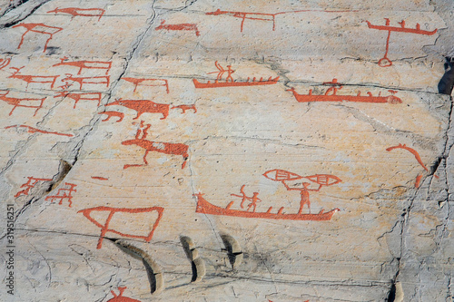 Rock art in Alta Fjord, Norway. Ancient symbols, real drawing collored with red ocher paint.