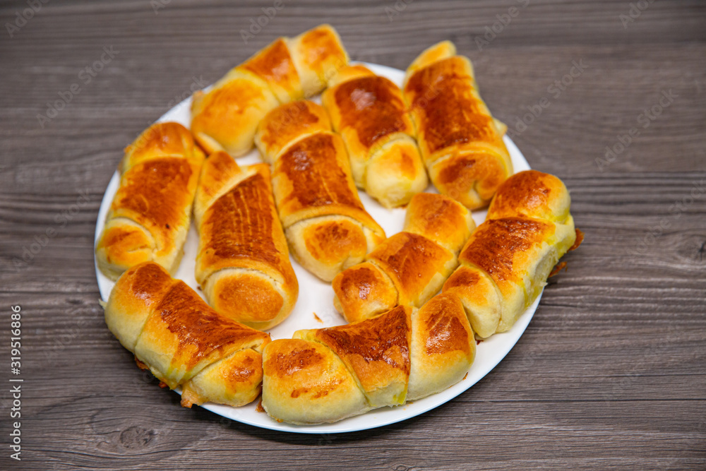 Fresh homemade croissants on wooden table, selective focus Fresh homemade croissants on wooden table, selective focus