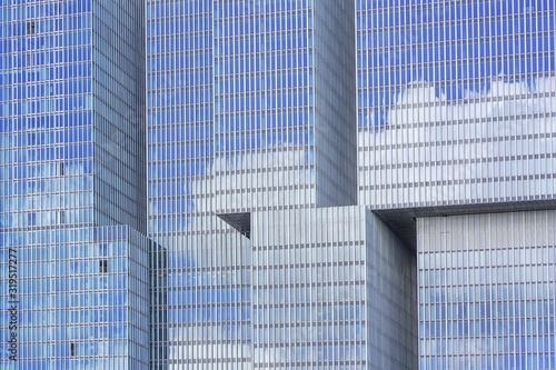 Glass blue square Windows of facade modern city business building skyscraper. Modern apartment buildings in new neighborhood. Abstract architecture. Windows of a building, texture.    