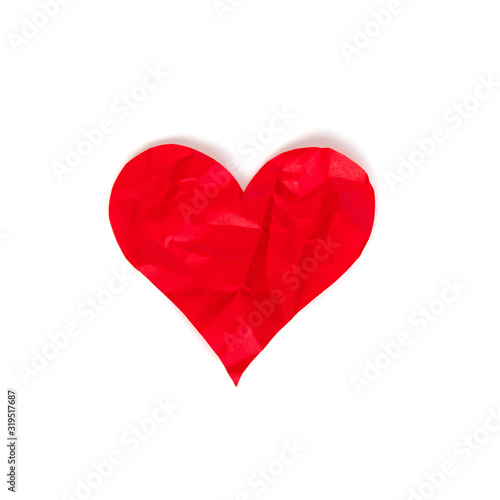 Red crumpled paper heart isolated on white background. Theme of divorce and unrequited love concept. Stock photo