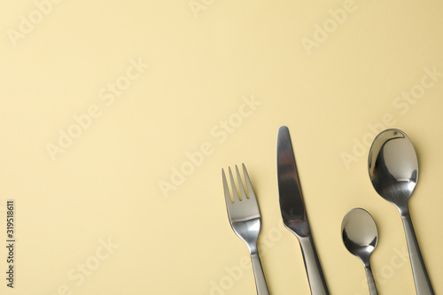 Cutlery on beige background  close up and space for text