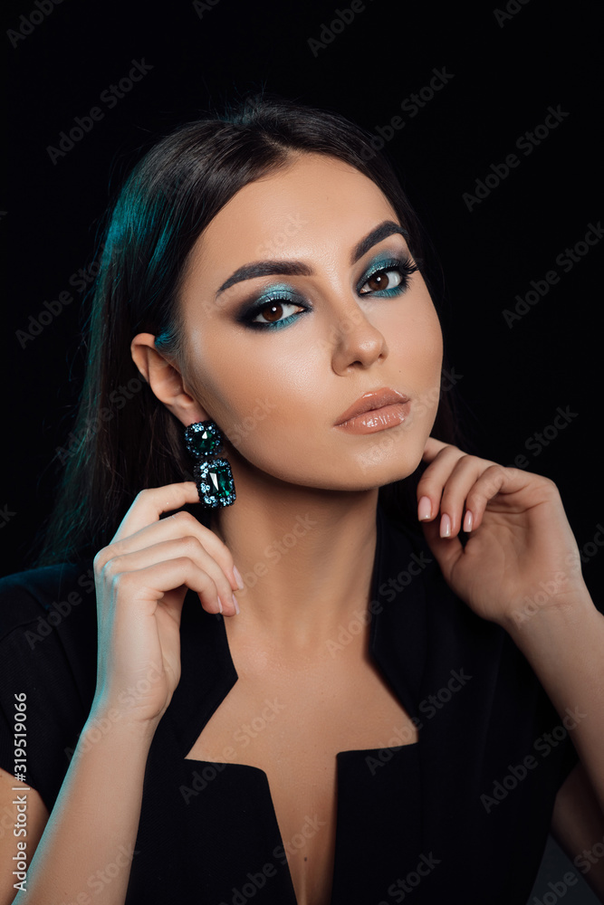 The sexy strict woman with makeup and a fashionable hairstyle poses in studio. Beauty fashion model girl with bright make up and manicure. Smooth hairstyle. Studio shot. Cosmetology and Spa The sexy strict woman with makeup and a fashionable hairstyle poses in studio. Beauty fashion model girl with bright make up and manicure. Smooth hairstyle. Studio shot. Cosmetology and Spa