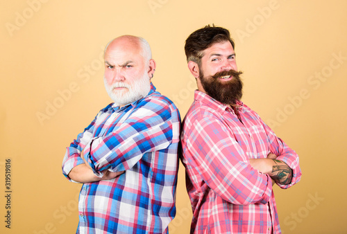 hipsters. father and son family. generational conflict. two bearded men senior and mature. barbershop and hairdresser salon. male beard care. checkered fashion. youth vs old age compare. retirement