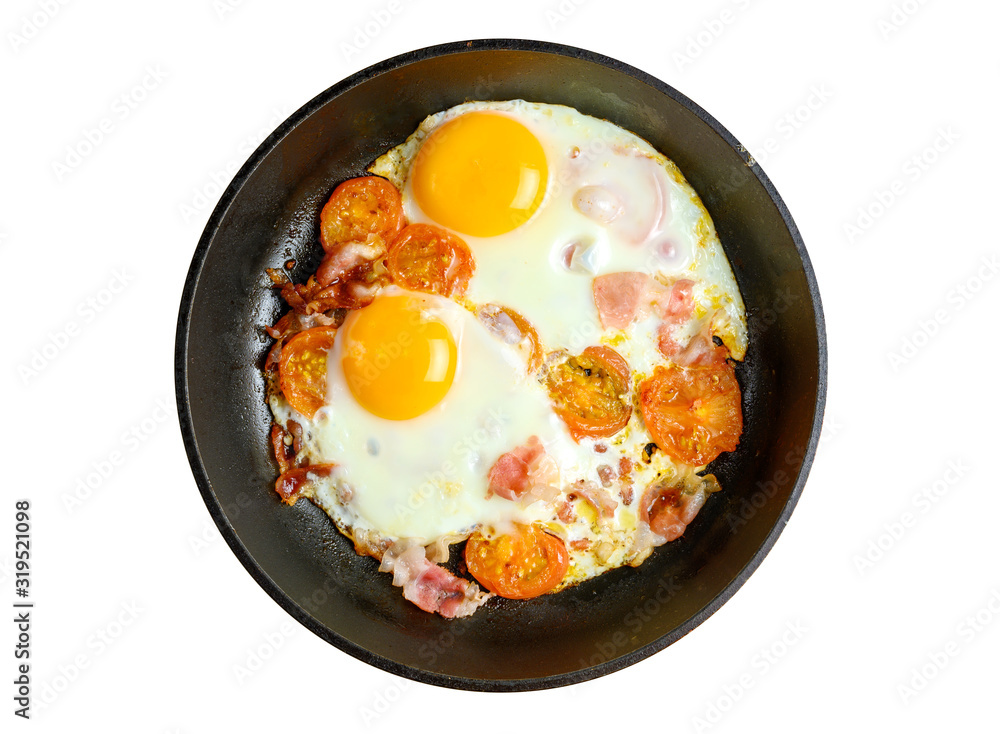 Fried eggs and bacon with tomatoes on frying pan isolated on white Fried eggs and bacon with tomatoes on frying pan isolated on white