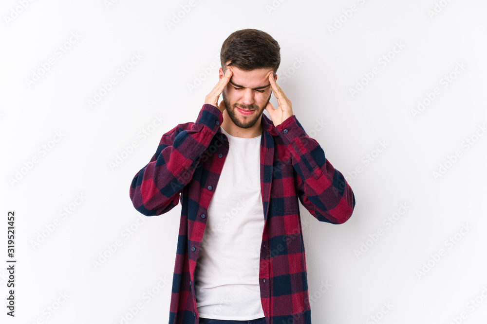 Young caucasian man posing in a white background isolated touching temples and having headache. Young caucasian man posing in a white background isolated touching temples and having headache.