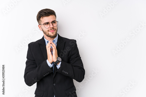 Young caucasian business man posing in a white background isolated Young caucasian business man making up plan in mind, setting up an idea.