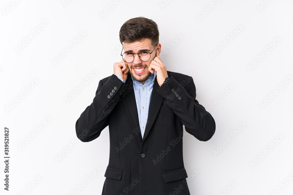 Young caucasian business man posing in a white background isolated Young caucasian business man covering ears with hands. Young caucasian business man posing in a white background isolated Young caucasian business man covering ears with hands.