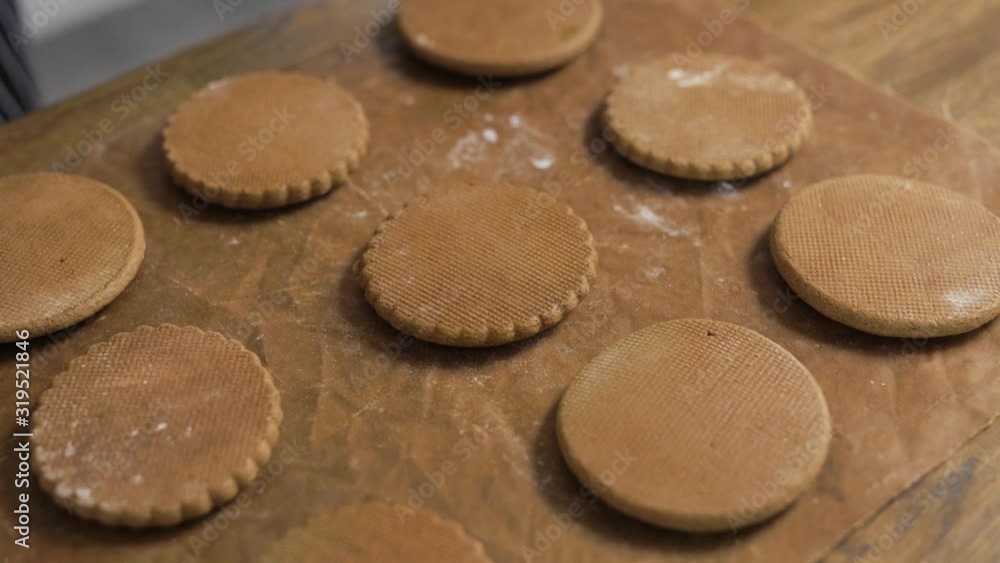 Baked gingerbread. The pastry chef lays out the finished cookies, uses parchment. Baked gingerbread. The pastry chef lays out the finished cookies, uses parchment.