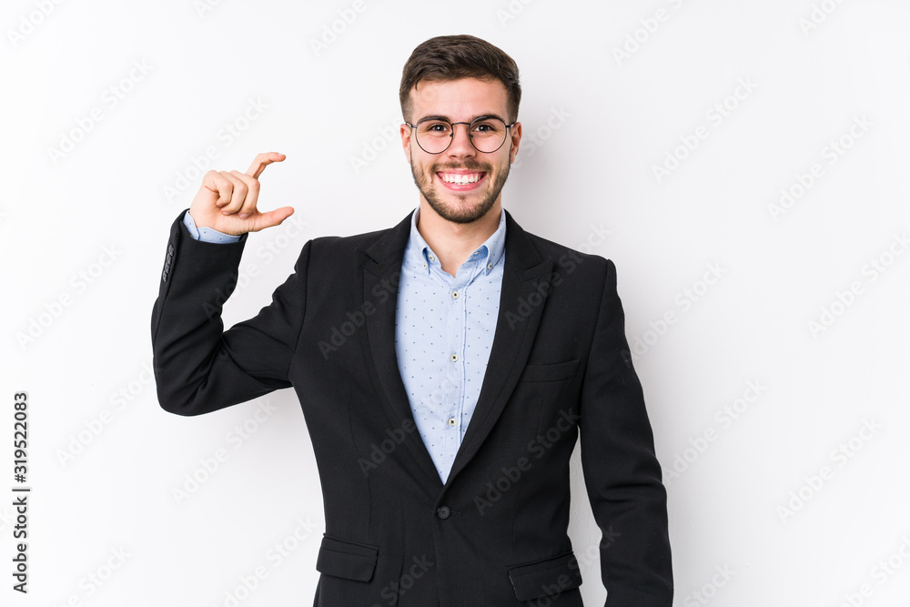 Young caucasian business man posing in a white background isolated Young caucasian business man holding something little with forefingers, smiling and confident. Young caucasian business man posing in a white background isolated Young caucasian business man holding something little with forefingers, smiling and confident.