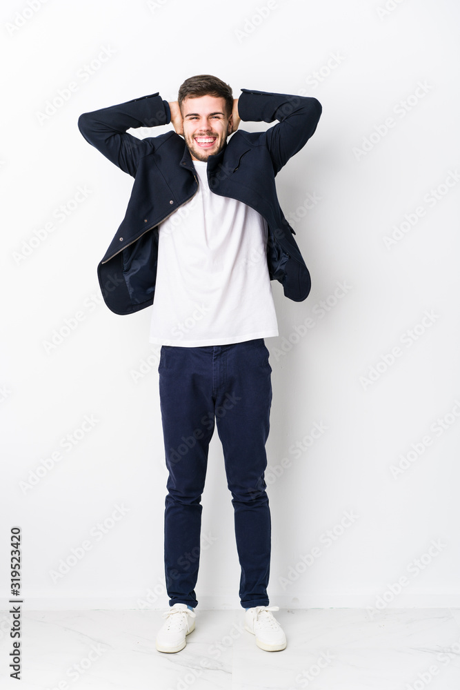 Full body young caucasian man isolated laughs joyfully keeping hands on head. Happiness concept. Full body young caucasian man isolated laughs joyfully keeping hands on head. Happiness concept.