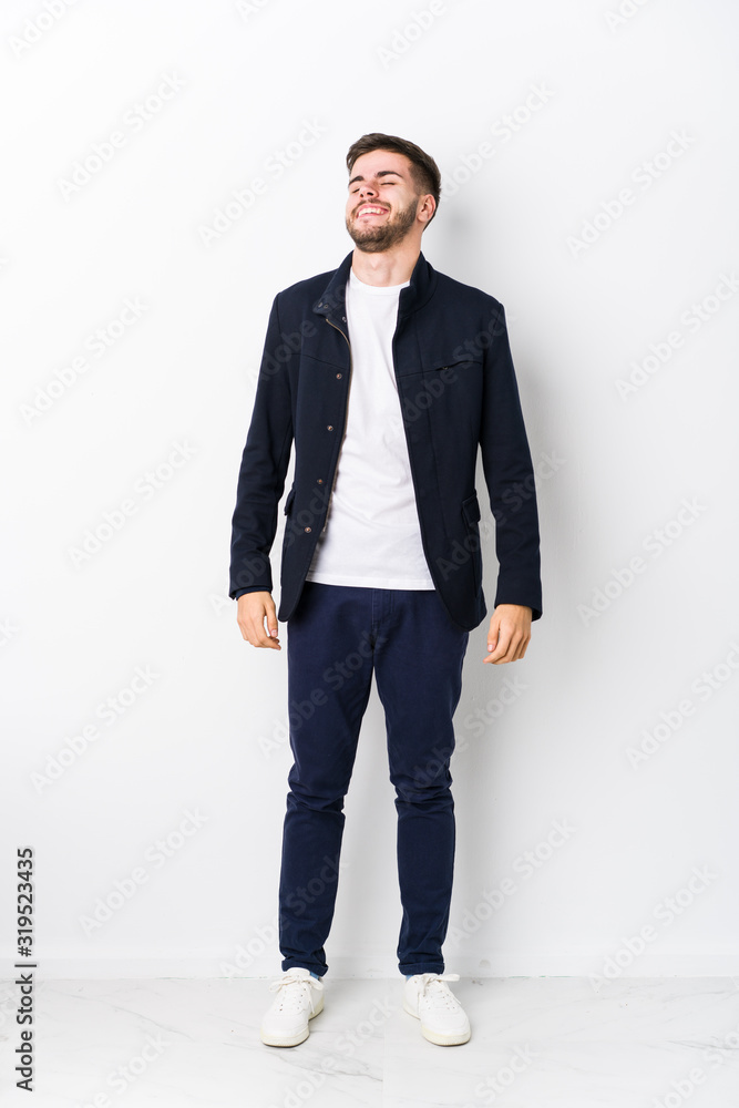 Full body young caucasian man isolated relaxed and happy laughing, neck stretched showing teeth. Full body young caucasian man isolated relaxed and happy laughing, neck stretched showing teeth.