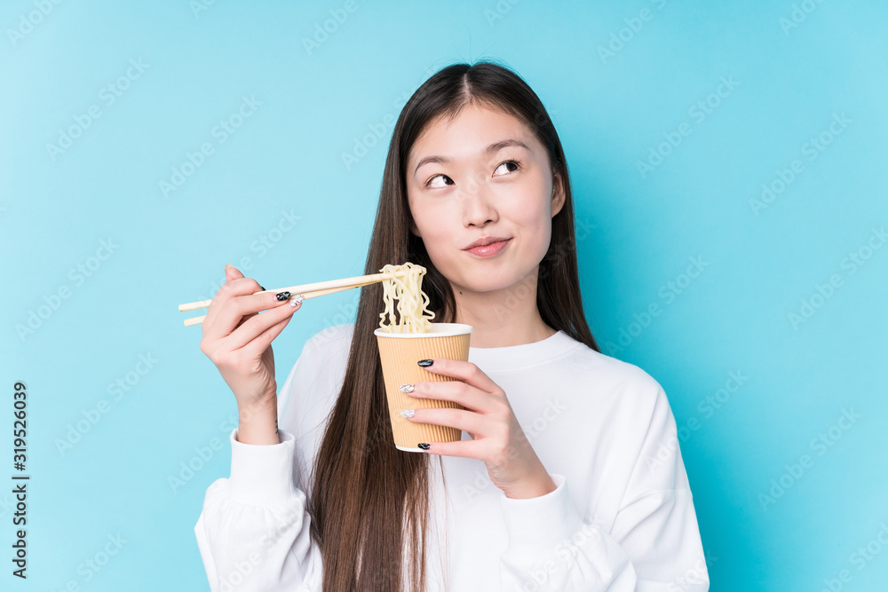 Young japanese woman eating noodles Young japanese woman eating noodles