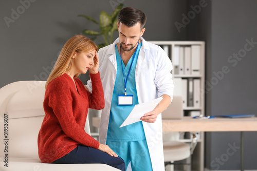 Male doctor working with pa...