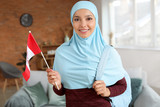Female Muslim student with Canadian flag at home