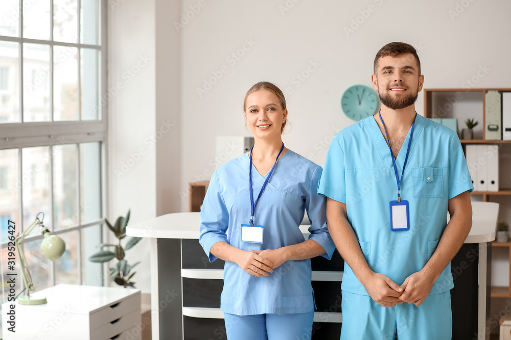 Male and female receptionists in clinic Male and female receptionists in clinic
