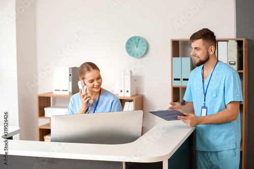 Male doctor near reception ...