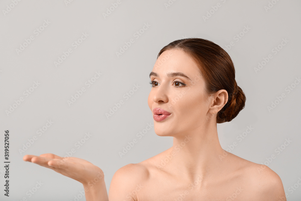 Beautiful young woman with healthy skin on light background Beautiful young woman with healthy skin on light background
