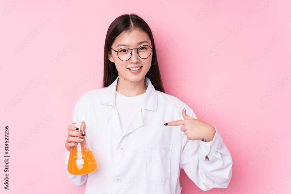 Young chinese scientific woman isolated person pointing by hand to a shirt copy space, proud and confident Young chinese scientific woman isolated person pointing by hand to a shirt copy space, proud and confident