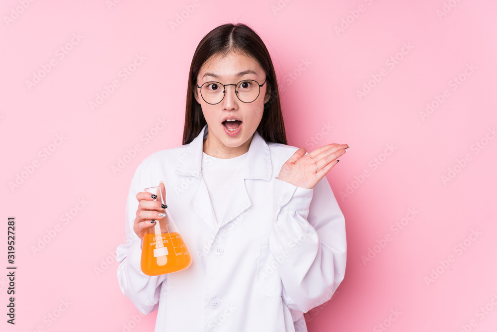 Young chinese scientific woman isolated surprised and shocked. Young chinese scientific woman isolated surprised and shocked.