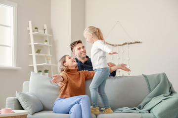 Portrait of happy young family at home