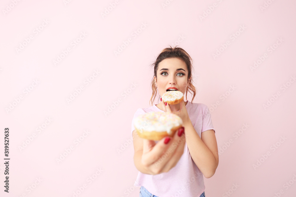 Beautiful young woman with donuts on color background Beautiful young woman with donuts on color background