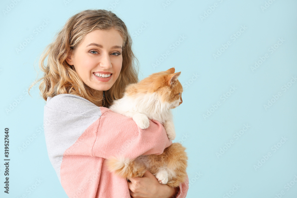 Beautiful young woman with cute cat on color background Beautiful young woman with cute cat on color background