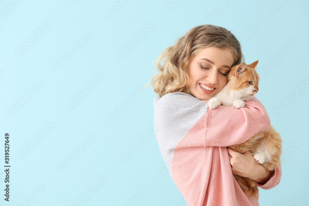 Beautiful young woman with cute cat on color background Beautiful young woman with cute cat on color background
