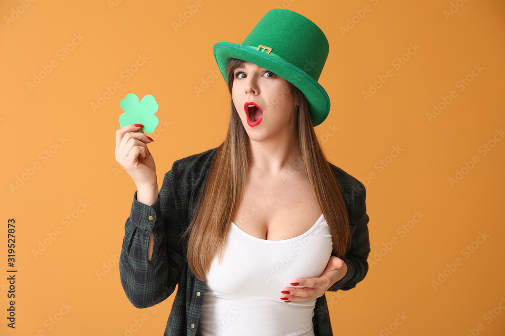 Funny young woman with paper clover on color background. St. Patrick's Day celebration Funny young woman with paper clover on color background. St. Patrick's Day celebration