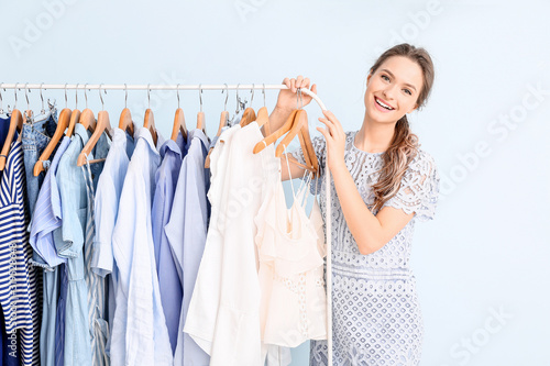 Female stylist near rack wi...