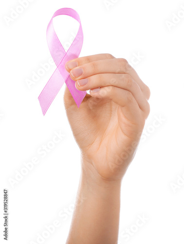 Female hand with pink ribbon on white background. Cancer awareness concept