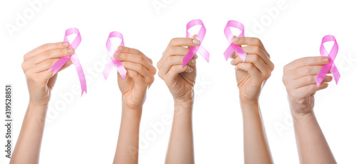 Female hands with pink ribbons on white background. Cancer awareness concept
