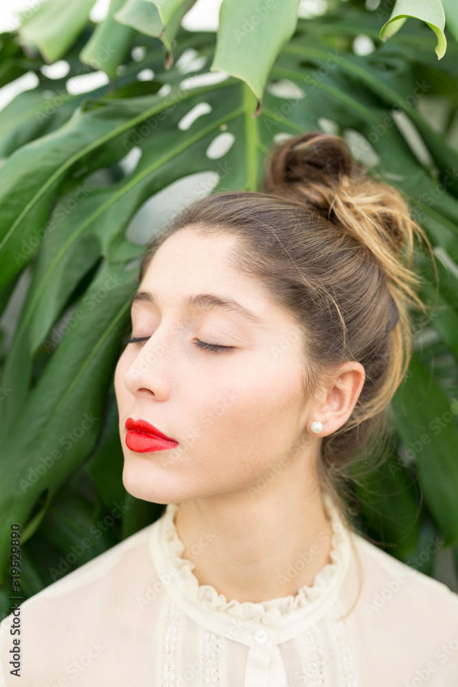 Portrait of young woman with red lips and eyes closed relaxing Portrait of young woman with red lips and eyes closed relaxing