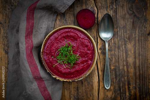 Bowl of vegan borscht with cress topping photo