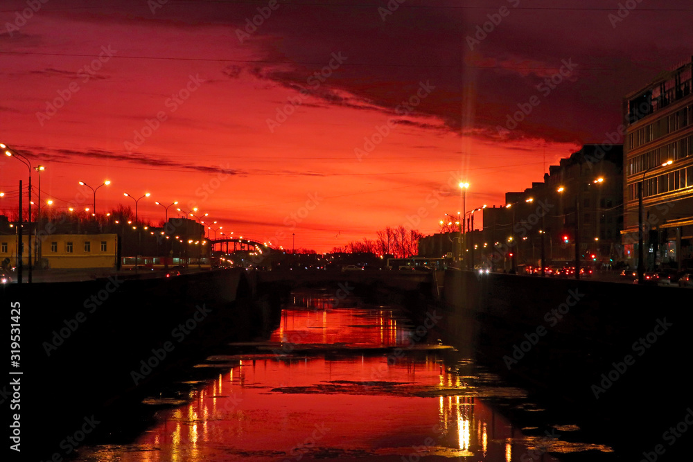 dawn with a beautiful red sky reflecting in the city canal
