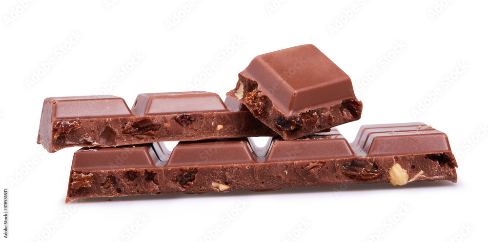 Milk chocolate. Chunks of chocolate with hazelnuts and raisins isolated on white background with clipping path. Milk chocolate. Chunks of chocolate with hazelnuts and raisins isolated on white background with clipping path.