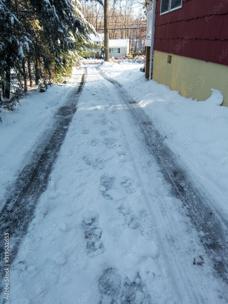 snowy and icy driveway in winter snowy and icy driveway in winter