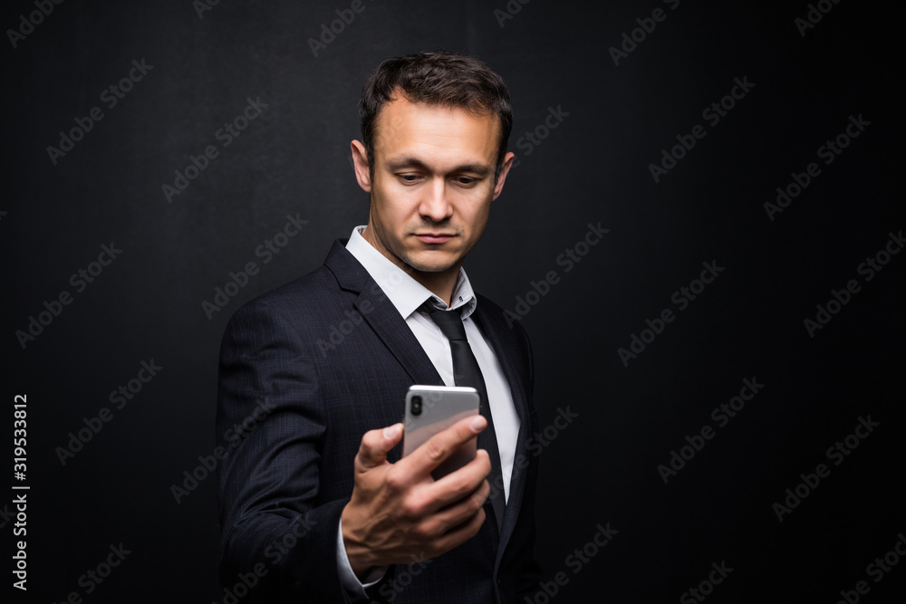 Portrait of cheerful businessman in suit surfing in internet Isolated on black background. Portrait of cheerful businessman in suit surfing in internet Isolated on black background.