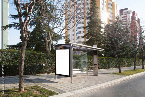 advertising board at bus stop on asphalt road